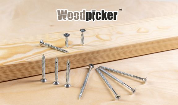 chipboard screws placed on a wooden board and screwed into a wooden beam